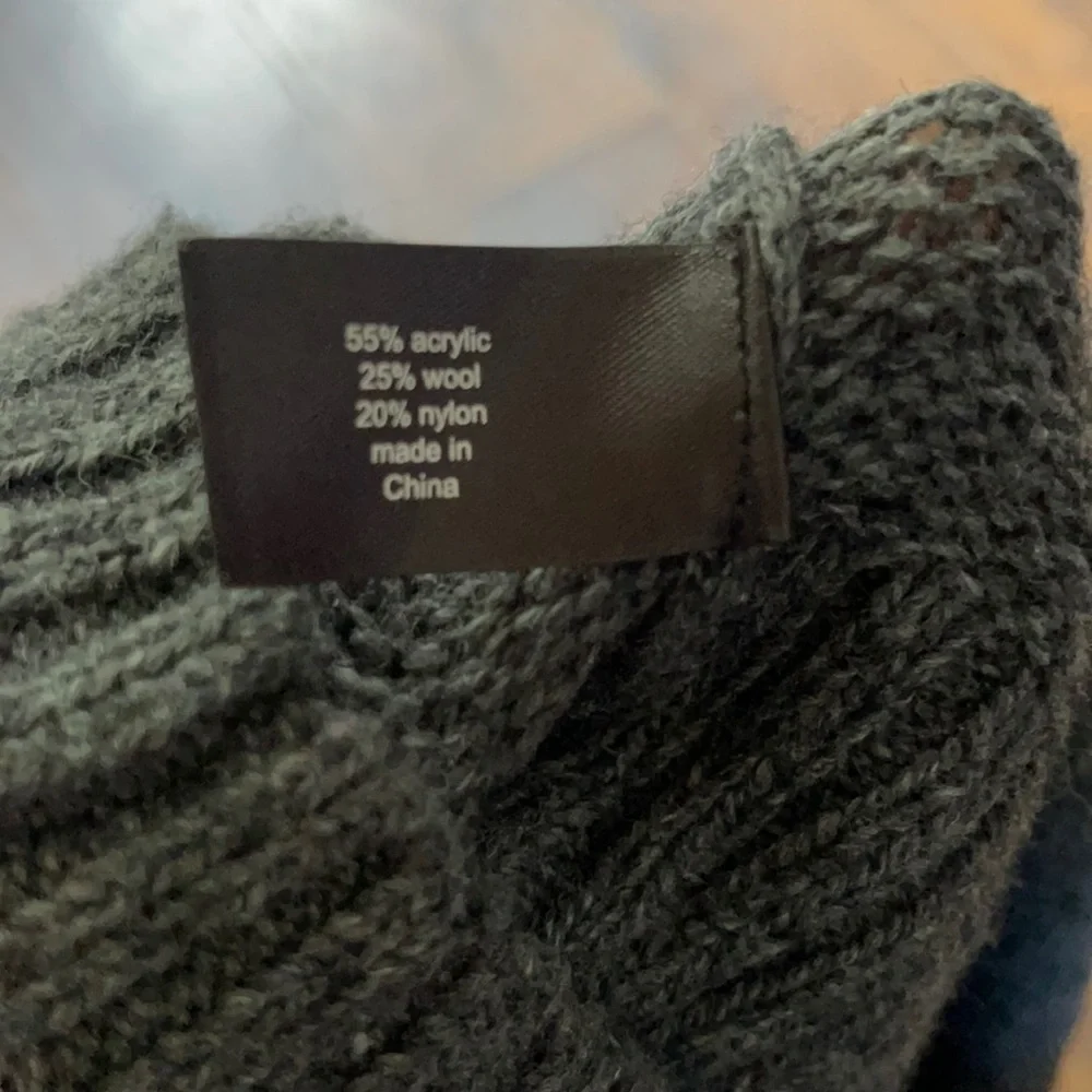 Lane Bryant- Gray sweater with flower embellishments round the neck.